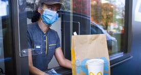 McDonald's employee assembling burgers