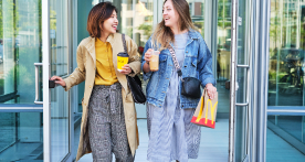 Two women leaving a McDonald's location holding food and drinks